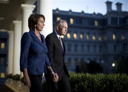 U.S. House Minority Leader Nancy Pelosi (D-CA) (L) and Senate Majority Leader Harry Reid (D-NV) walk from the West Wing of the White House in Washington, October 2, 2013, following a meeting with U.S. President Barack Obama, House Speaker John Boehner (R-OH), and Senate Minority Leader Mitch McConnell (R-KY). Obama met with Republican and Democratic leaders in Congress on Wednesday to try to break a deadlock that has shut down wide swaths of the federal government, but there was no breakthrough. REUTERS/Jason Reed