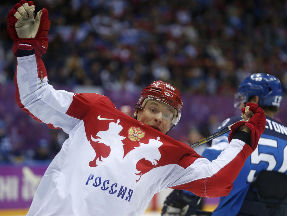 Russia forward Alexander Syomin loses his balance against Finland in the third period of a men's quarterfinal ice hockey game at the 2014 Winter Olympics, Wednesday, Feb. 19, 2014, in Sochi, Russia. (AP Photo/Julio Cortez)