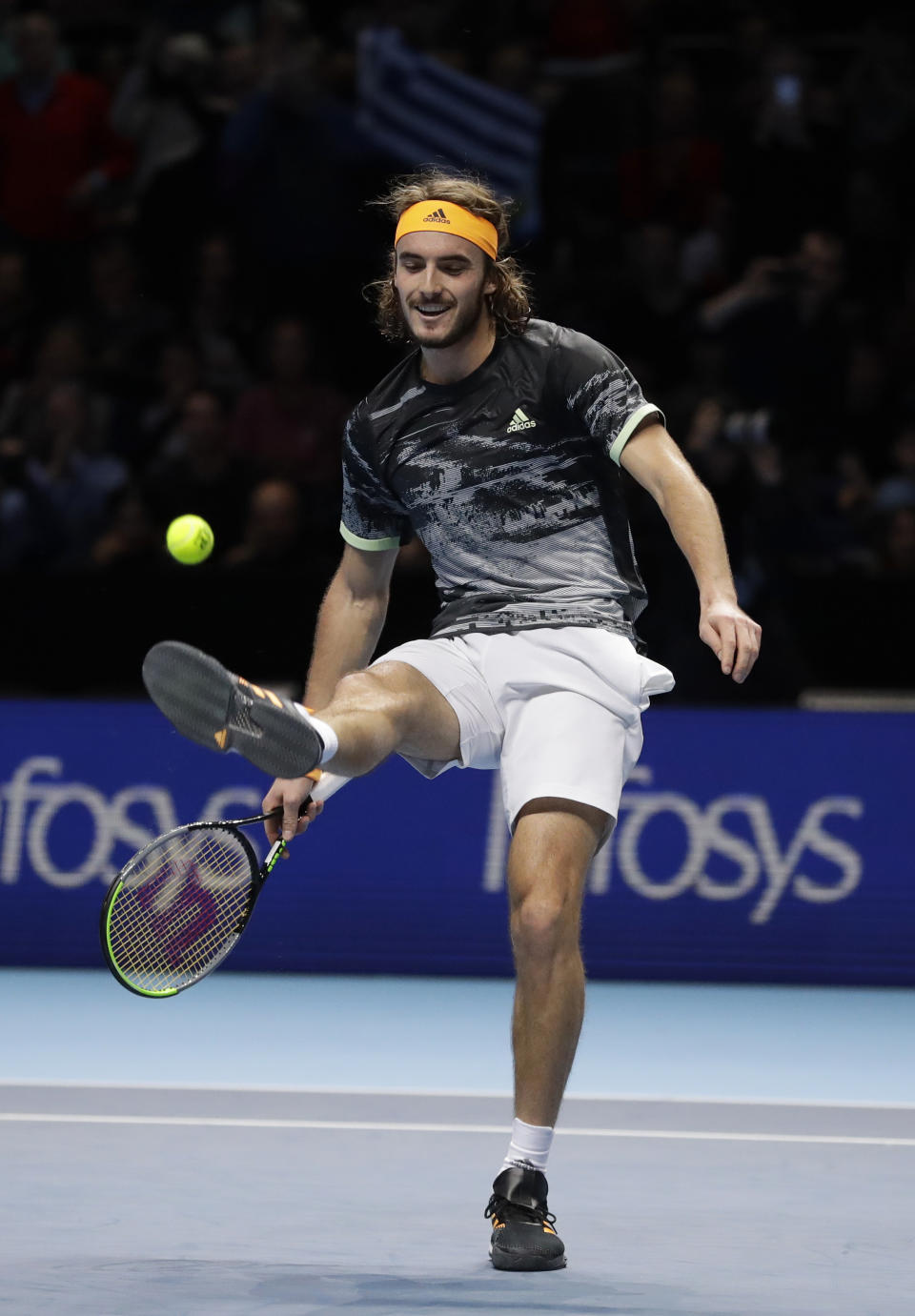 Stefanos Tsitsipas of Greece kicks the ball as he celebrates winning match point against Roger Federer of Switzerland during their ATP World Tour Finals semifinal tennis match at the O2 Arena in London, Saturday, Nov. 16, 2019. (AP Photo/Kirsty Wigglesworth)