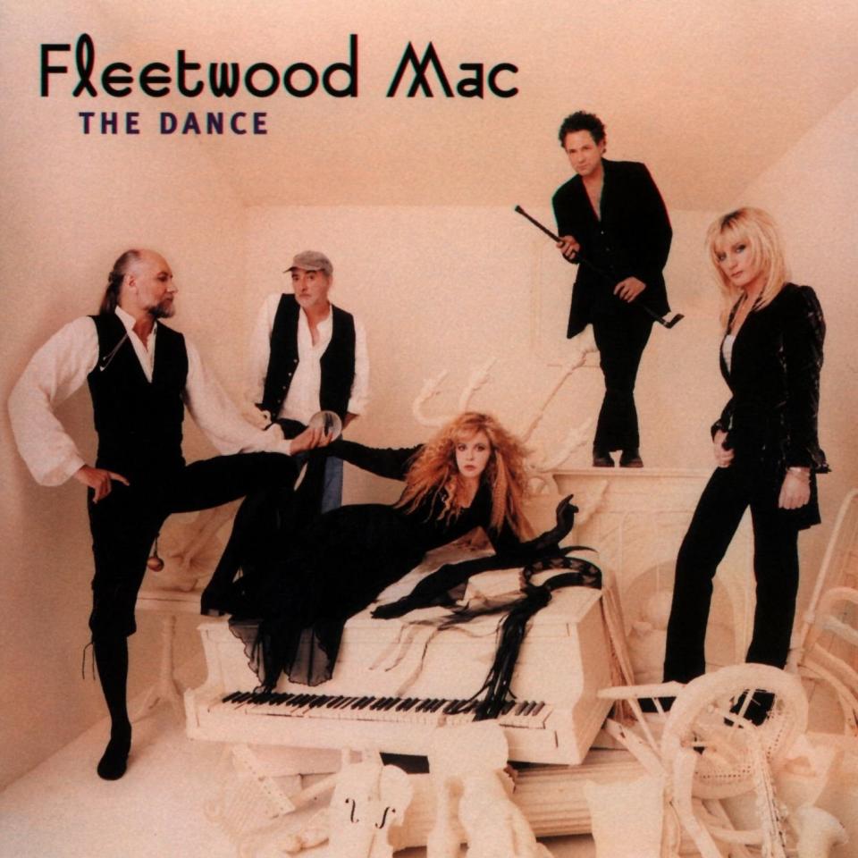 the album cover with band members in a room with toppled over furniture and piano