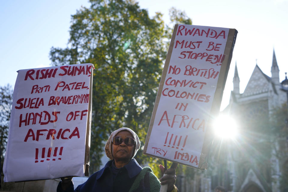 A protester stands outside the Supreme Court in London, Wednesday, Nov. 15, 2023. Britain's highest court is set to rule Wednesday, Nov. 15 on whether the government's plan to send asylum-seekers to Rwanda is legal, delivering a boost or a blow to a contentious central policy of Prime Minister Rishi Sunak's administration. Five justices on the U.K. Supreme Court will deliver judgment in the government's attempt to overturn a lower court ruling that blocked deportations. (AP Photo/Kirsty Wigglesworth)