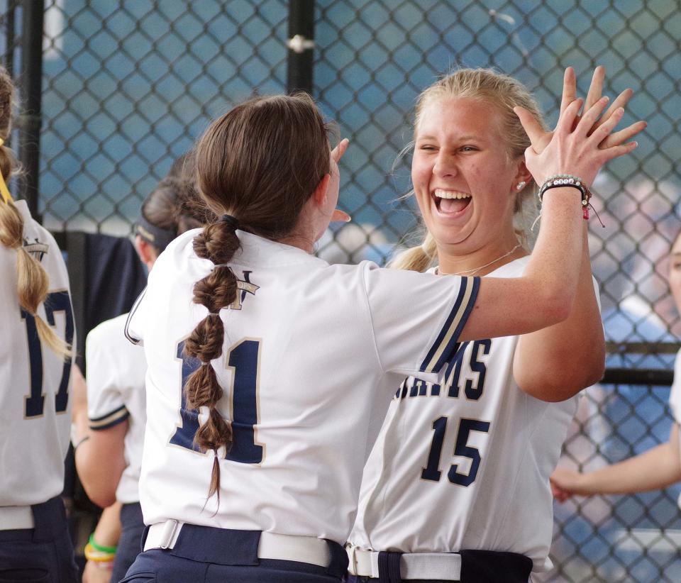 Archies starting pitcher Jillian Ondrick gets a high five from teammate Josephine Whitney after Ondrick helped bat in a run to help tie the game with Case at 3 in the top of the 5th in the semis at Worcester State on Wed. June 14, 2023.