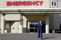 Caroline Maloney stands outside HonorHealth's Scottsdale Osborn Medical Center at the end of her overnight shift early Friday, June 26, 2020 in Scottsdale, Ariz. Arizona nurses and doctors find themselves on the frontline as the coronavirus rips through the state, making it one of the world's hot spots. (AP Photo/Matt York)