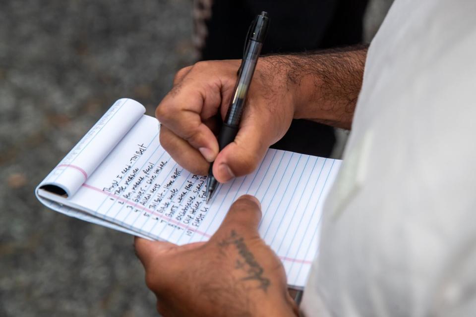 A ManifestWorks participant takes notes during class