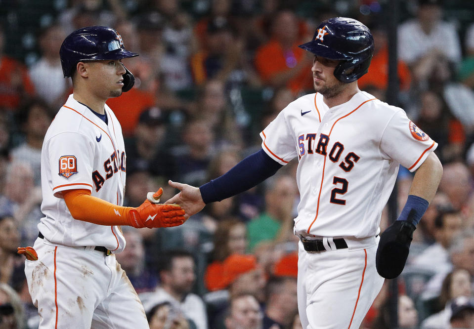 Houston Astros' Alex Bregman, right, is greeted by Aledmys Diaz after scoring during the second inning of the team's baseball game against the Kansas City Royals on Tuesday, July 5, 2022, in Houston. (AP Photo/Kevin M. Cox)