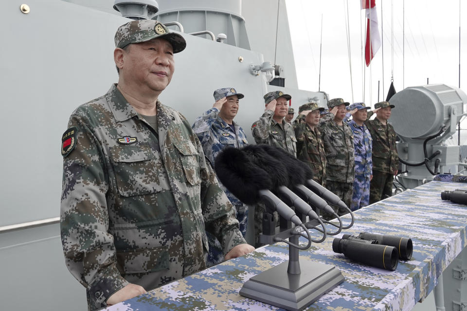 FILE - In this April 12, 2018, file photo released by Xinhua News Agency, Chinese President Xi Jinping speaks after reviewing the Chinese People's Liberation Army (PLA) Navy fleet in the South China Sea. Xi is calling on the PLA to better prepare for combat, amid tensions over Taiwan and the South China Sea. China says it will not "renounce the use of force" in efforts to reunify Taiwan with the mainland and vows to take all necessary military measures to defeat "separatists." (Li Gang/Xinhua via AP, File)