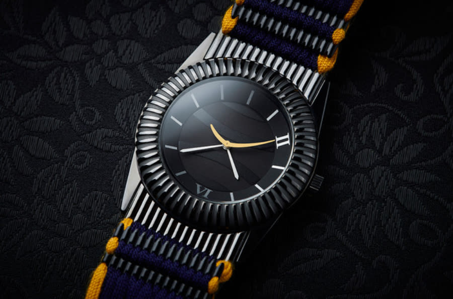 A close-up look at a watch made to look like Japanese armor, which is set against a black background.