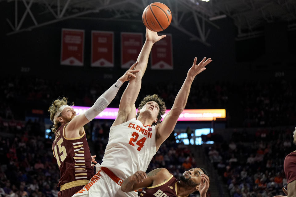 Clemson center PJ Hall (24) shoots against Boston College's Mason Madsen (45) and Claudell Harris Jr. (1) during the first half of an NCAA college basketball game, Saturday, Jan. 13, 2024, in Clemson, S.C. (AP Photo/Mike Stewart)