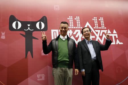 Alibaba Group CEO Jonathan Lu (L) and Alibaba Group COO Daniel Zhang pose for a photo at the company's headquarters in Hangzhou, Zhejiang province November 11, 2014. REUTERS/Aly Song