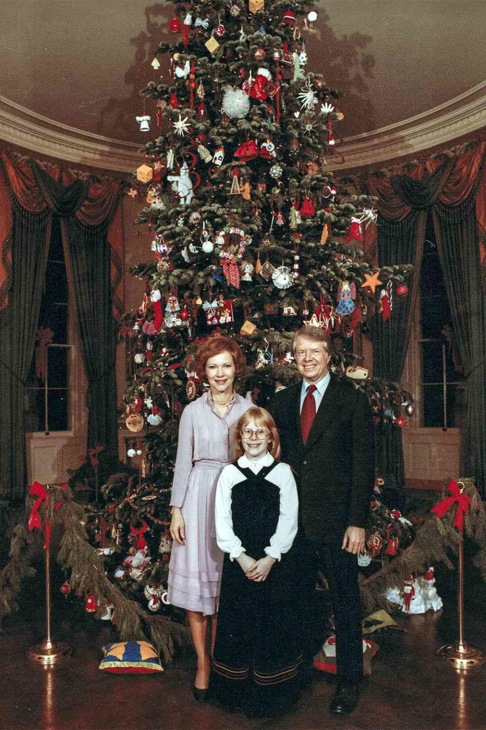 <p>Merry Christmas from the Carters! The first couple poses with their daughter Amy, then 10, before a spangled evergreen.</p> <p>While serving as first lady, Rosalynn was known to host lower-key festivities at the White House, compared to the parties of her predecessors. </p> <p>"She brings her own taste to her entertaining; white wine instead of hard liquor, classical music instead of nightclub humor, and open houses for the handicapped and the aged as well as politicians and potentates," <a href="https://www.washingtonpost.com/archive/lifestyle/1977/05/15/the-crafts-awakening-at-the-white-house/5c48f630-3e3f-4532-99f5-0995113bcad1/" rel="nofollow noopener" target="_blank" data-ylk="slk:The Washington Post;elm:context_link;itc:0;sec:content-canvas" class="link "><em>The Washington Pos</em>t</a> reported at the time.</p>