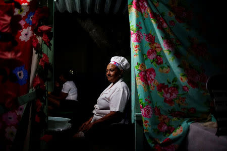 A chef sits in a food station during the recording of an episode of the popular TV show "Palmas y Canas" in the village of Providencia, in the Sierra Maestra, Cuba, March 29, 2018. REUTERS/Alexandre Meneghini