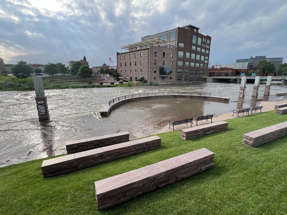 The Big Sioux River is seen rushing Friday, June 21, 2024, through downtown Sioux Falls at high levels after torrential rain overnight.