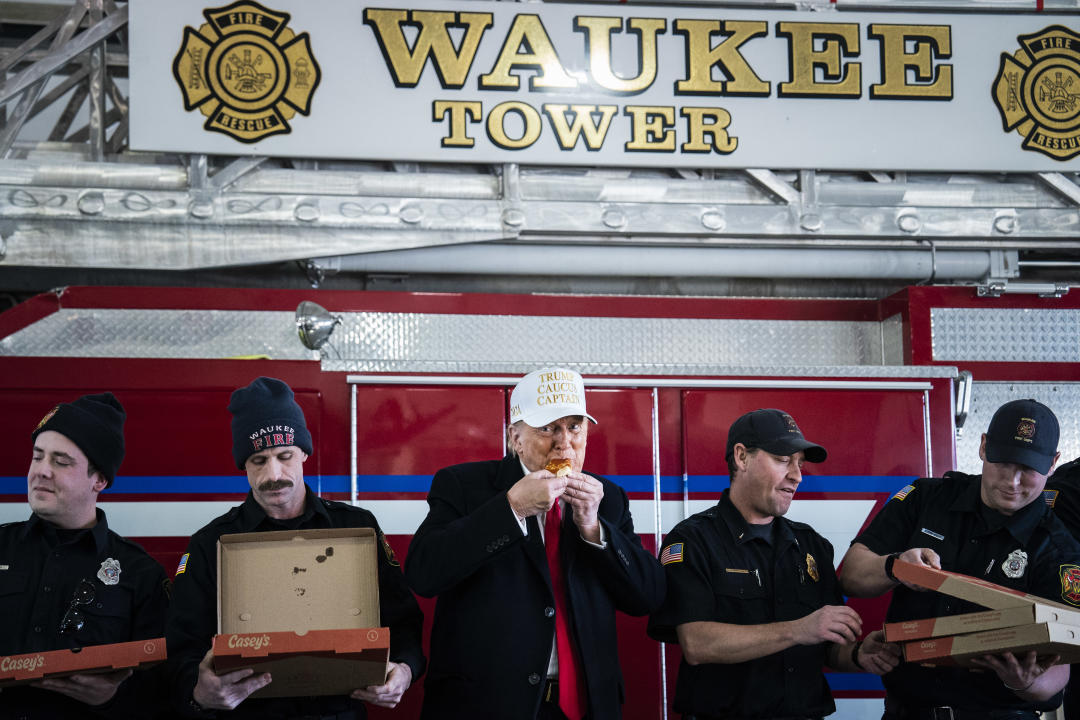 Former President Donald Trump eats pizza with firefighters at the Waukee Fire Department in Waukee, Iowa.