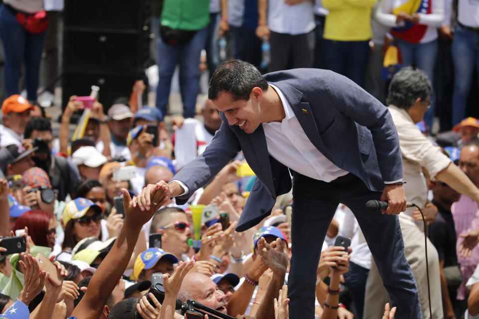 Venezuela's opposition leader and self proclaimed president Juan Guaido, greets the crowd during a rally in Caracas, Venezuela, Saturday, April 27, 2019. The Trump administration has added Venezuelan Foreign Minister Jorge Arreaza to a Treasury Department sanctions target list as it increases pressure on Guaido's opponent, embattled President Nicolas Maduro. (AP Photo/Fernando Llano)