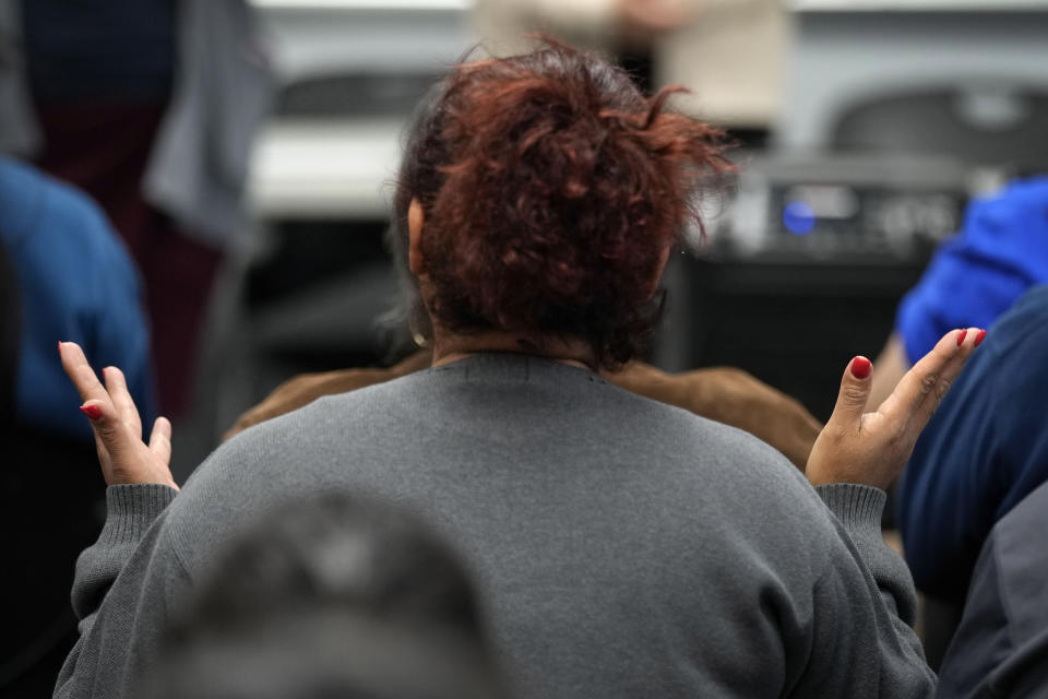 An audience member asks a question during an Iowa Migrant Movement for Justice informational meeting, Wednesday, March 27, 2024, in Des Moines, Iowa. A bill in Iowa that would allow the state to arrest and deport some migrants is stoking anxiety among immigrant communities about how it would be interpreted and enforced. (AP Photo/Charlie Neibergall)