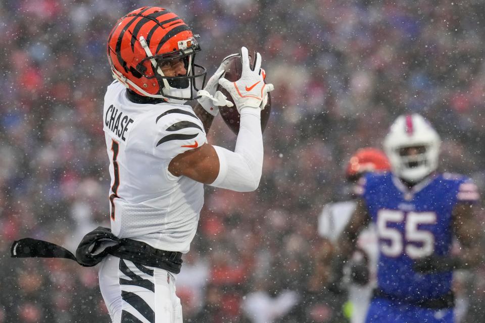 Cincinnati Bengals wide receiver Ja'Marr Chase (1) catches a pass before turning in for a touchdown during Sunday's NFL divisional playoff game against the Buffalo Bills.