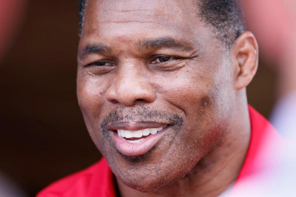 FILE – Herschel Walker, the Republican nominee for the state’s U.S. Senate seat, takes questions from the media after a campaign event July 20, 2022, in Athens, Ga. Senate GOP nominee Herschel Walker is making every effort to shape the contest as a referendum on what his campaign calls the “Biden-Warnock” agenda. (Miguel Martinez/Atlanta Journal-Constitution via AP, File)