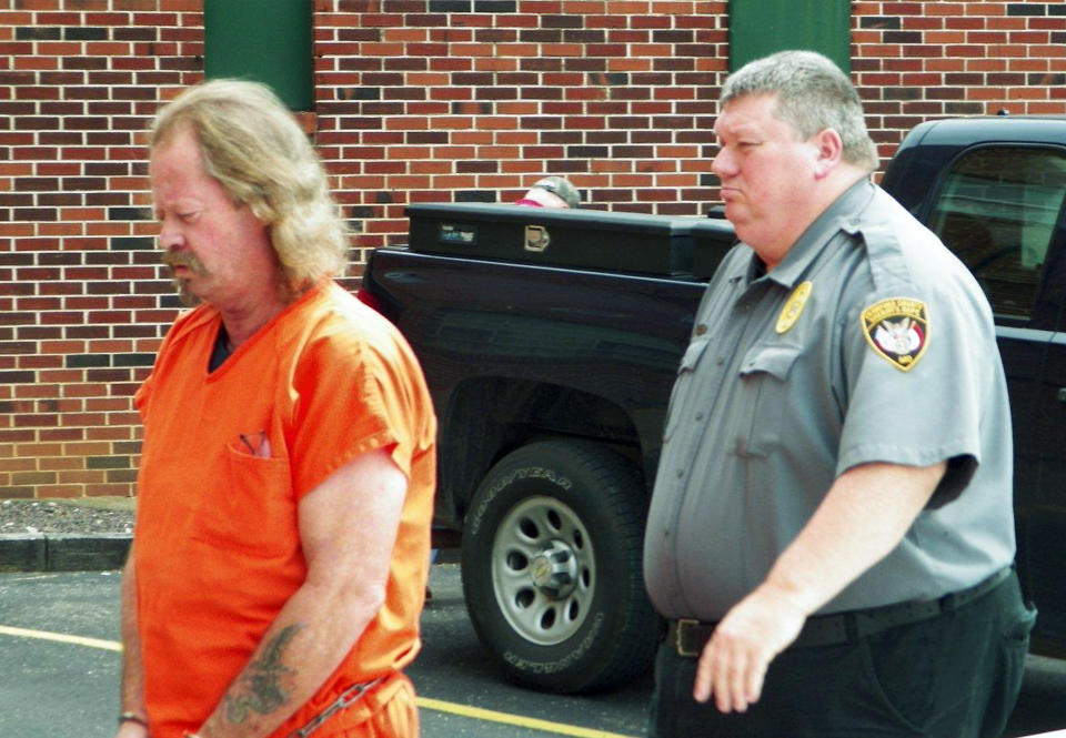 In a Aug. 16, 2013, photo James Crocker, left, is escorted to court for a prelimiary hearing in Steeleville, Mo. Crocker had grown weary of the canoe and float trip partiers encroaching on his neatly kept property along Missouri’s Meramec River. When he caught a man on a gravel bar by his yard last month, a nasty confrontation ensued that ended with one person dead and Crocker accused of killing him. (AP Photo/Jim Salter)