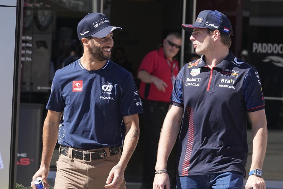 AlphaTauri driver Daniel Ricciardo, left, of Australia, talks with Red Bull driver Max Verstappen, of the Netherlands, as they leave a news conference at the Formula One U.S. Grand Prix auto race at Circuit of the Americas, Thursday, Oct. 19, 2023, in Austin, Texas. (AP Photo/Darron Cummings)