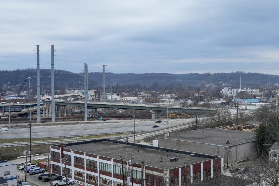 The new interchange from southbound Interstate 75 to westbound Interstate 74 is visible from a garage at Cincinnati State Technical and Community College, with the former home of Worthmore Food Products Co., 1021 Ludlow Ave., in the foreground.