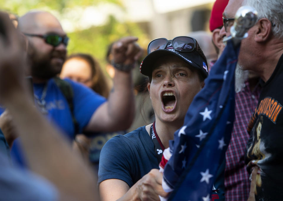 A supporter, foreground, of Republican Reps. Marjorie Taylor Greene and Matt Gaetz shouts as other supporters and counterprotesters spar verbally, during a protest held by Greene and Gaetz outside City Hall on Saturday, July, 17, 2021, in Riverside, Calif. (Cindy Yamanaka/The Orange County Register via AP)