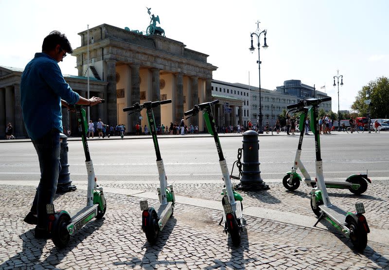 FILE PHOTO: E-scooters of California-based bicycle service Lime are pictured by the Brandenburg Gate in Berlin