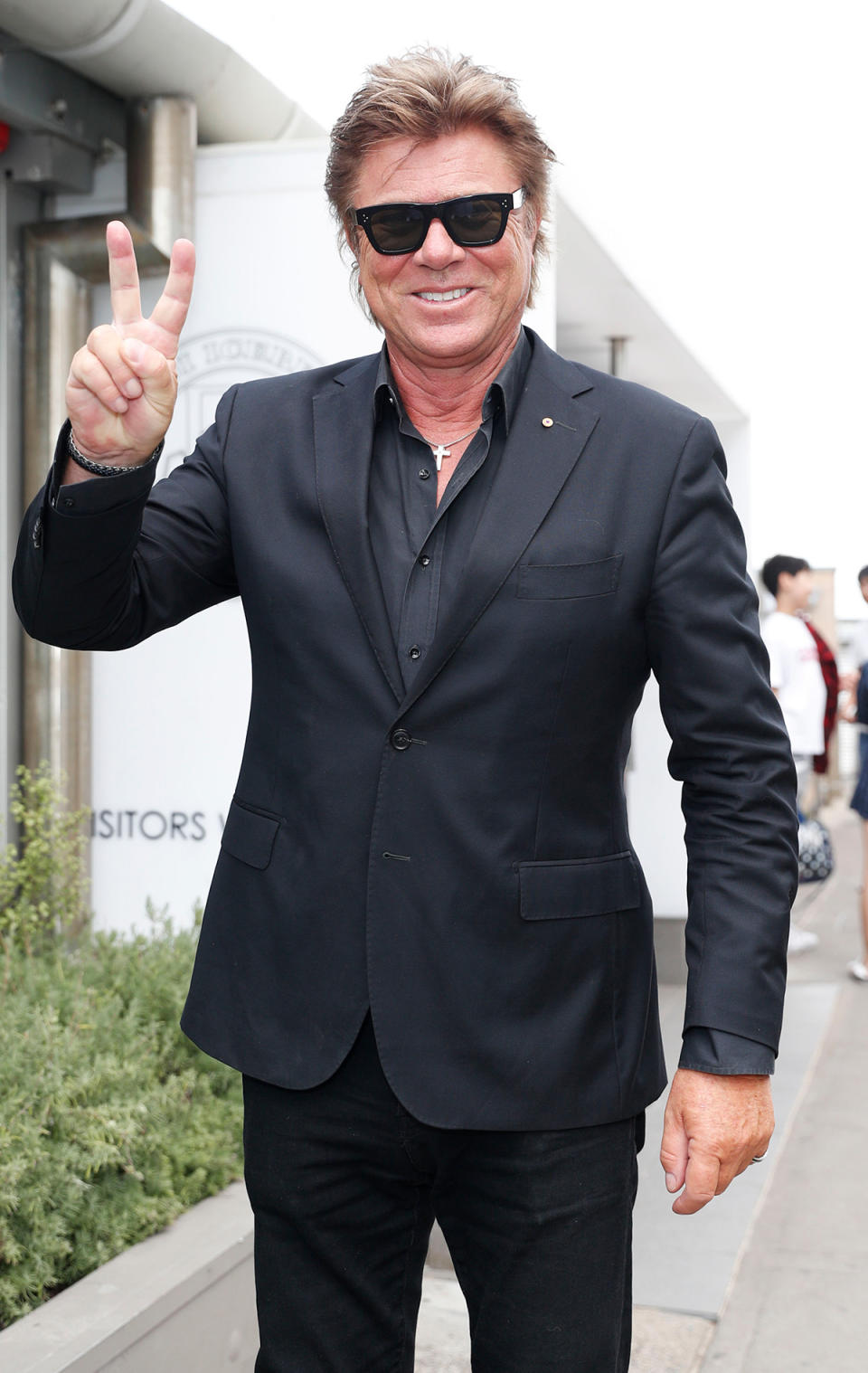 Richard Wilkins giving the peace sign to the camera while wearing sunglasses