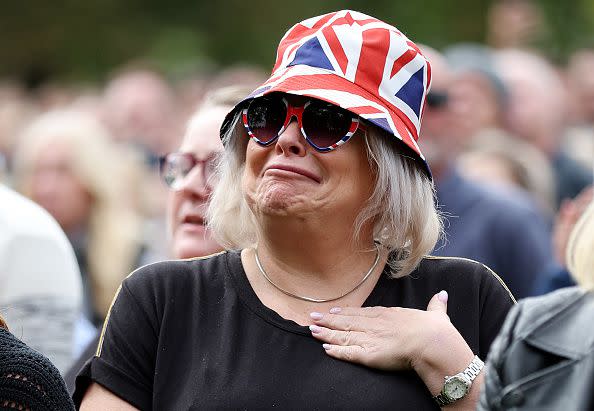 WINDSOR, ENGLAND - SEPTEMBER 19: A member of the public reacts on September 19, 2022 in Windsor, England. The committal service at St George's Chapel, Windsor Castle, took place following the state funeral at Westminster Abbey. A private burial in The King George VI Memorial Chapel followed. Queen Elizabeth II died at Balmoral Castle in Scotland on September 8, 2022, and is succeeded by her eldest son, King Charles III. (Photo by Alex Pantling/Getty Images)