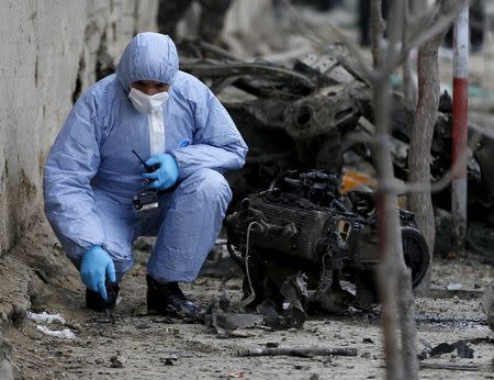 A member of the Afghan security forces investigates at the site of a suicide attack in Kabul March 25, 2015. REUTERS/Omar Sobhani