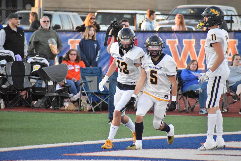 Mooresville's Nate Thomas (13) celebrates with Kade Garrett (5) after scoring a touchdown against Whiteland on Sept. 30, 2022.