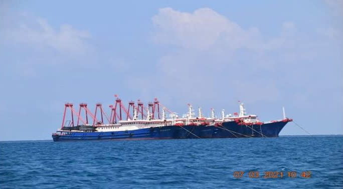 Some of the about 220 vessels reported by the Philippine Coast Guard are pictured at Whitsun Reef, South China Sea