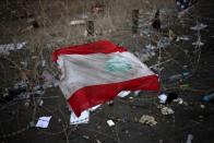 A Lebanese national flag is placed on barbed wire next to the Government Palace during a protest in downtown Beirut