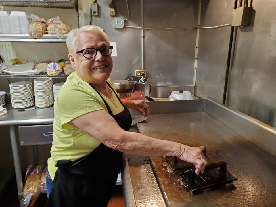 Ellie Carte, 80, works at one of the grills at Ala Carte Cafe in downtown Port Clinton. A former co-owner — Aunt
Ellie to the current owners — she still helps out at the restaurant four days a week.