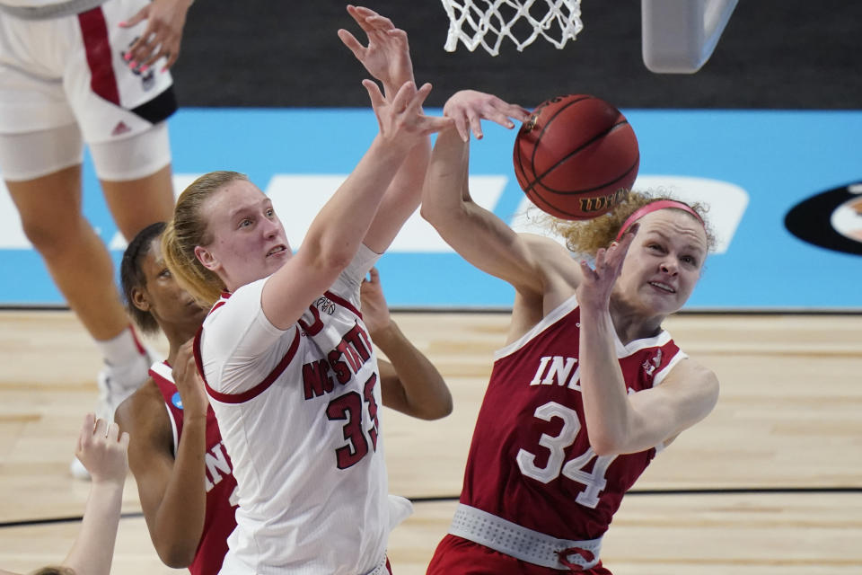 North Carolina State center Elissa Cunane (33) and Indiana guard Grace Berger (34) battle for control of a rebound during the first half of a college basketball game in the Sweet Sixteen round of the women's NCAA tournament at the Alamodome in San Antonio, Saturday, March 27, 2021. (AP Photo/Eric Gay)