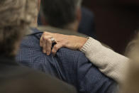 Karen Wilson, mother of Anna Moriah Wilson, grips the shoulder of her husband, Eric Wilson, during the sentencing portion of Kaitlin Armstrong's murder trial at the Blackwell-Thurman Criminal Justice Center on Friday, Nov. 17, 2023, in Austin, Texas. Armstrong was found guilty of killing Wilson in May 2022 and sentenced to 90 years in prison. (Mikala Compton/Austin American-Statesman via AP, Pool)