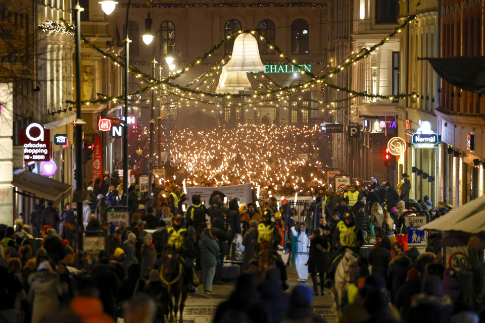 People participate in a torchlight procession in honor of the Nobel Peace Prize laureate in Oslo, Norway, Sunday Dec. 10, 2023. Narges Mohammadi was awarded the 2023 Nobel Peace Prize in October for her decades of activism despite numerous arrests by Iranian authorities and spending years behind bars. She is renowned for campaigning for women's rights and democracy in her country, as well as fighting against the death penalty. (Hanna Johre/NTB via AP)