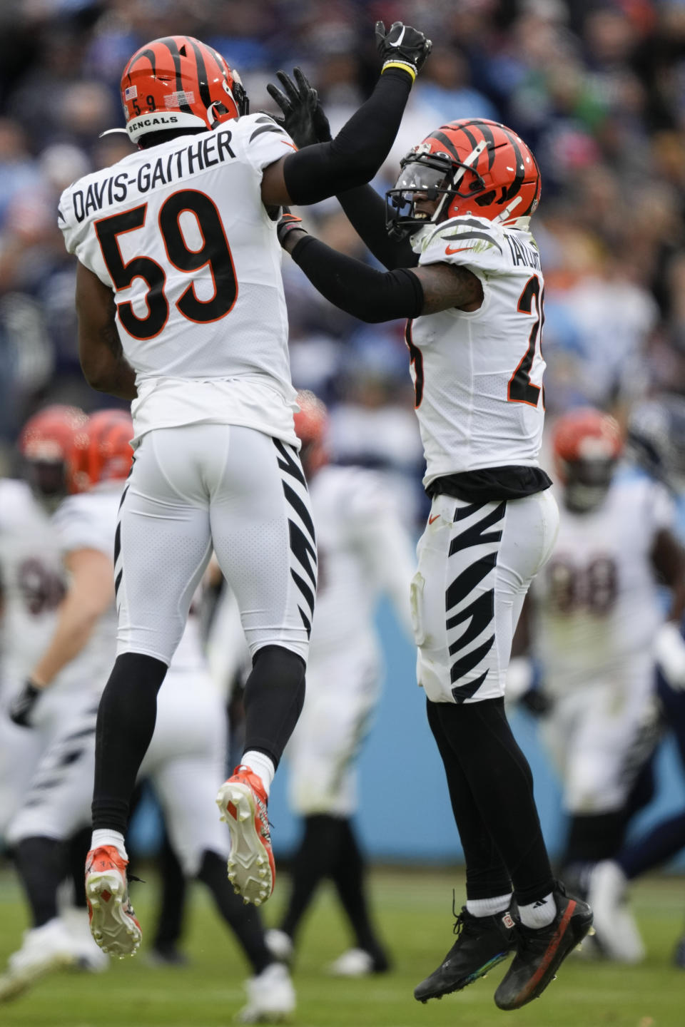 Cincinnati Bengals cornerback Cam Taylor-Britt (29) and linebacker Akeem Davis-Gaither (59) celebrate a misses Tennessee Titans field goal attempt during the first half of an NFL football game, Sunday, Nov. 27, 2022, in Nashville, Tenn. (AP Photo/Gerald Herbert)