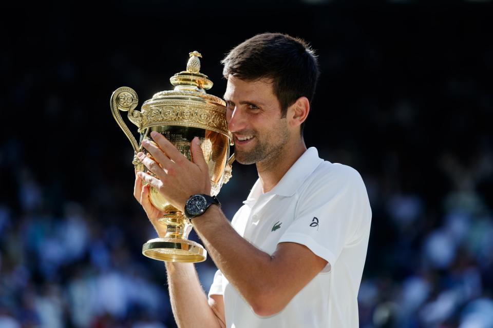 <p>Novak Djokovic celebrates winning a fourth Wimbledon title with the trophy. The Serbian claimed a first grand slam title in more than two years by beating Kevin Anderson. He added the US Open title to show he is far from finished (John Walton/PA). </p>