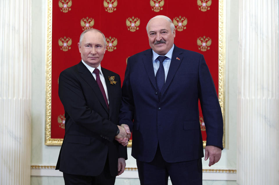 Russian President Vladimir Putin, left, and Belarusian President Alexander Lukashenko shake hands at their meeting during the 78th anniversary of the end of World War II celebrations in Moscow, Russia, Monday, May 9, 2022. (Vladimir Smirnov, Sputnik, Kremlin Pool Photo via AP)