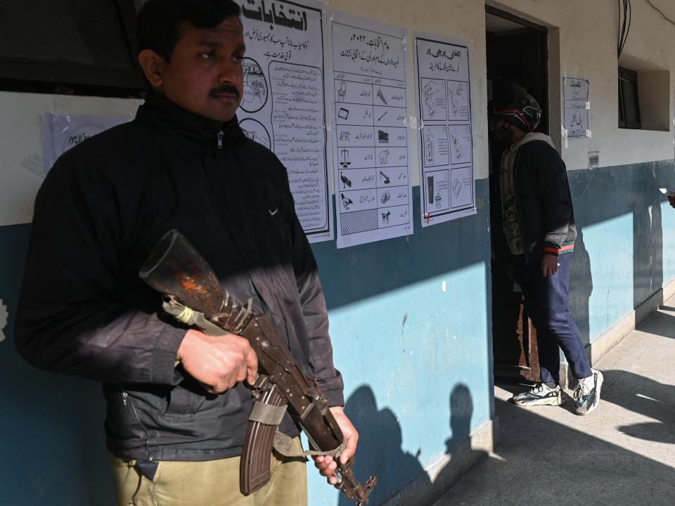 A policeman stands guard at a polling station during Pakistan’s national elections in Lahore on February 8, 2024. Millions of Pakistanis began voting February 8 in an election marred by allegations of poll rigging, with the country’s most popular politician in jail and a military-favoured candidate tipped to win (AFP via Getty Images)