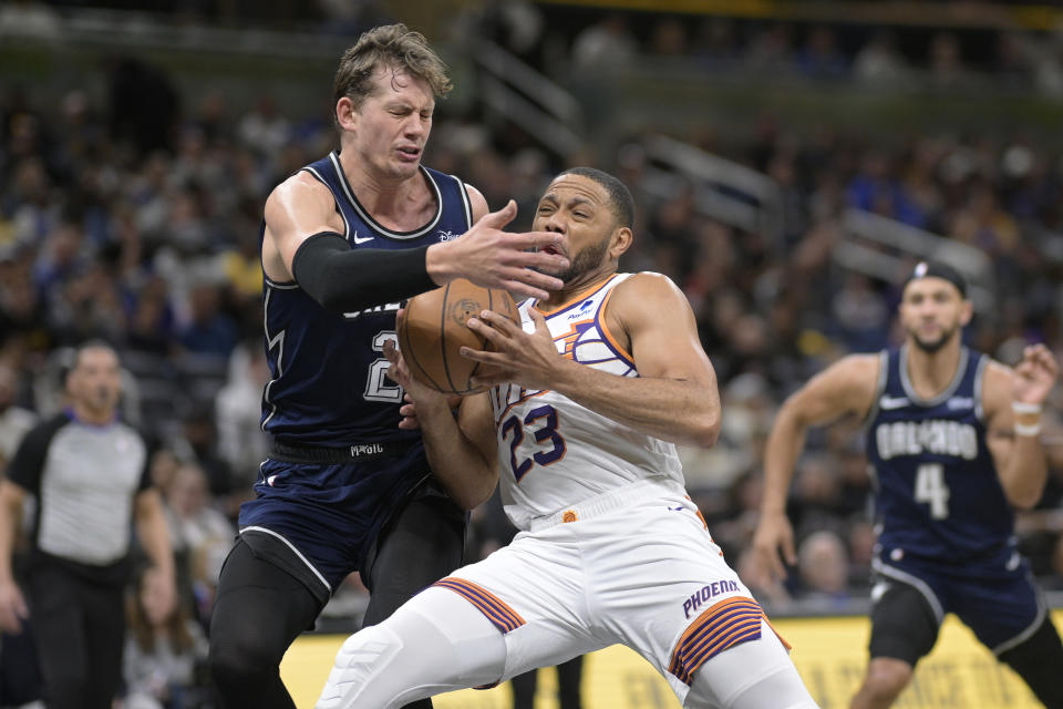 Phoenix Suns guard Eric Gordon (23) drives to the basket as Orlando Magic center Moritz Wagner, left, defends during the first half of an NBA basketball game, Sunday, Jan. 28, 2024, in Orlando, Fla. (AP Photo/Phelan M. Ebenhack)