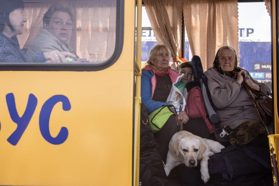 ZAPORIZHZHIA, UKRAINE - MAY 02: Women from the frontline town of Orikhiv wait on a bus after arriving at an evacuation point for people fleeing Mariupol, Melitopol and the surrounding towns under Russian control on May 02, 2022 in Zaporizhzhia, Ukraine. Dozens of refugees were expected to arrive here from Mariupol, including the Azovstal steel facility, following extensive negotiations between representatives of Ukraine, Russia, the United Nations and the International Committee of the Red Cross. (Photo by Chris McGrath/Getty Images)