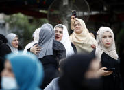 Muslims greet each other after prayers on the first day of Eid al-Fitr holiday outside Abu Hanifa mosque in Baghdad, Iraq, Thursday, May 13, 2021. Eid al-Fitr marks the end of the Muslims' holy fasting month of Ramadan. (AP Photo/Hadi Mizban)