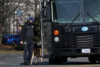 A bomb sniffing dog goes around a bus full of National Guard troops after it arrived at the Capitol, Saturday, Jan. 16, in Washington ahead of the inauguration of President-elect Joe Biden and Vice President-elect Kamala Harris. (AP Photo/Julio Cortez)