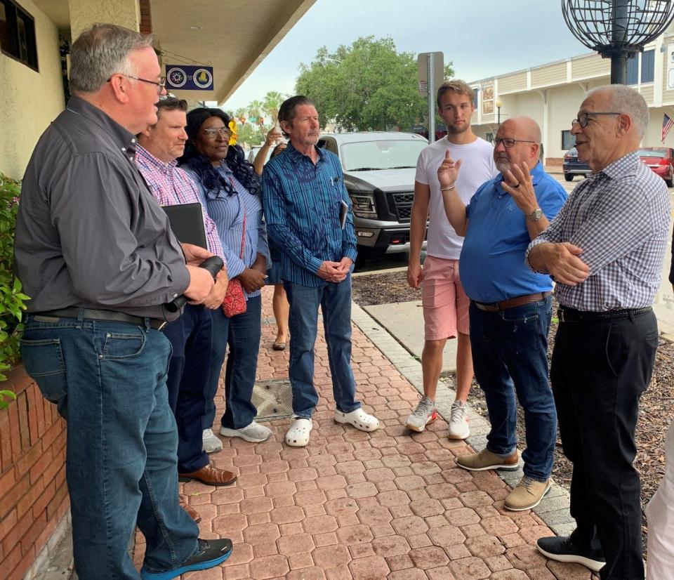 Former Vero Beach Mayor, large downtown property owner and Florida Rep. Robbie Brackett, second from right, tells Victor Dover, left, an urban and street designer, about the evolution of 14th Avenue during an unofficial tour Tuesday July 18, 2023. Others on the tour include, second from left, Jason Jeffries, the city's planning and development director; Jerusha Stewart, Bob Stanley, Jonathan Buckley, Brackett and Mayor John Cotugno.