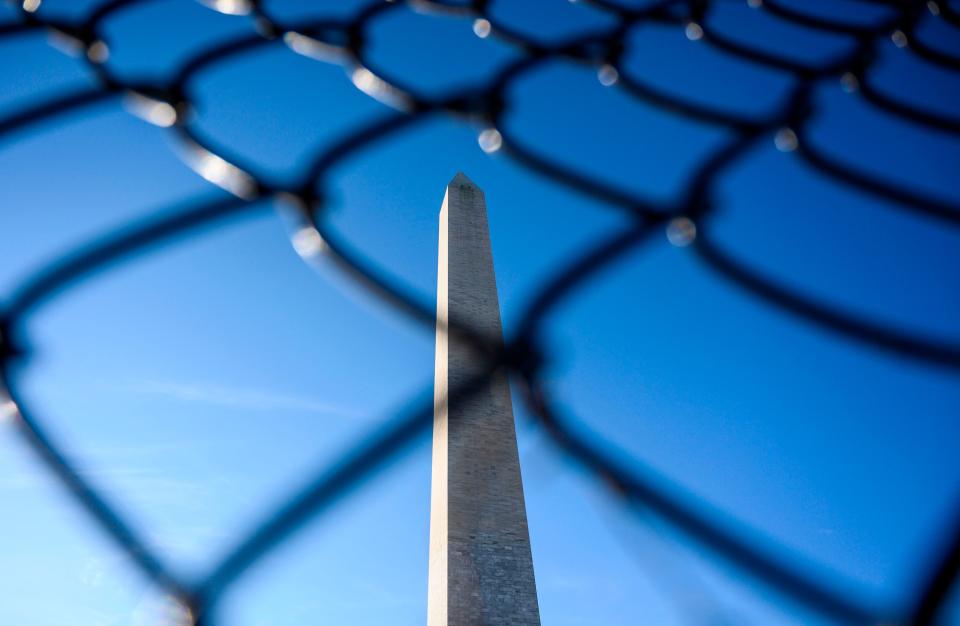 The Washington Monument is seen through a chain link fence during a government shutdown in Washington, DC, Dec. 27, 2018. Congress members trickled back into Washington but there was little hope of ending the government shutdown sparked by a row with President  Trump over his demand for US-Mexico border wall construction.