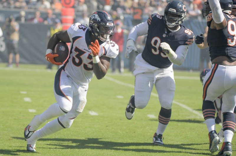 Denver Broncos running back Javonte Williams (L) runs the ball against the Chicago Bears on Sunday at Soldier Field in Chicago. Photo by Mark Black/UPI