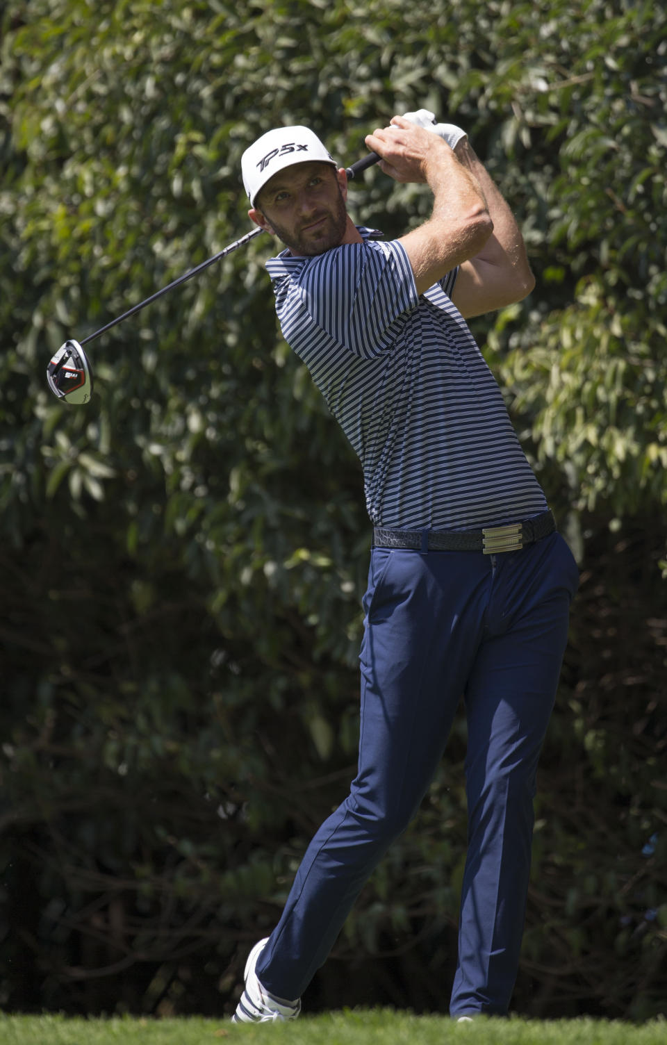 U.S. golfer Dustin Johnson watches his ball in the second hole during the WGC-Mexico Championship at the Chapultepec Golf Club in Mexico City, Sunday, Feb. 24, 2019. (AP Photo/Christian Palma)