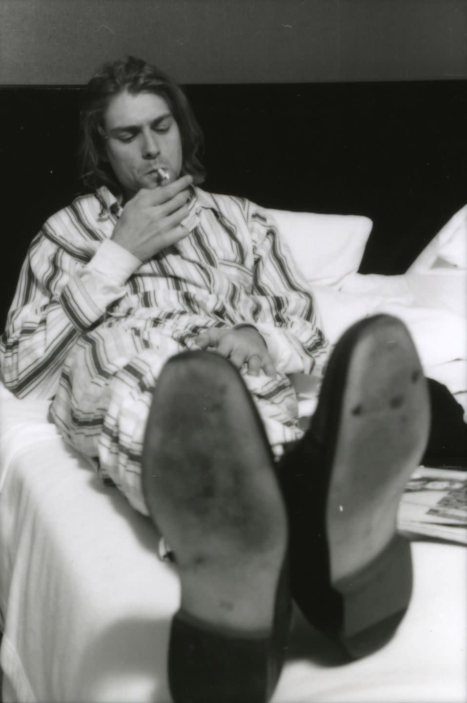 <p>Kurt Cobain of Nirvana, lying in bed wearing pyjamas and smoking a cigarette in Roppongi Prince Hotel in Tokyo, Japan, during an interview, 19th December 1992.</p>