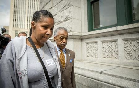 Rev. Al Sharpton (R) and Esaw Garner, wife of Eric Garner who died after being put in a choke hold by a New York City police officer, arrive to meet with Brooklyn U.S. Attorney Loretta Lynch, at her offices in the Brooklyn borough of New York, August 21, 2014. REUTERS/Brendan McDermid